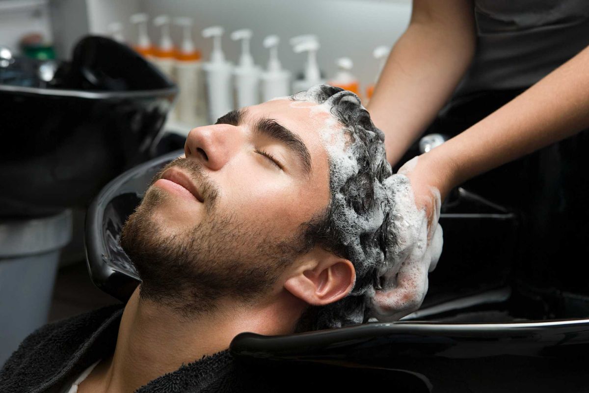 Homem lavando o cabelo em um salão de beleza