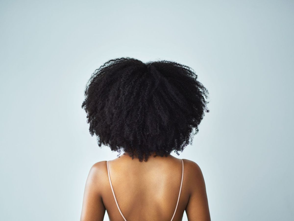 Rückseite der schwarzen Frau mit schönen lockigen Haaren